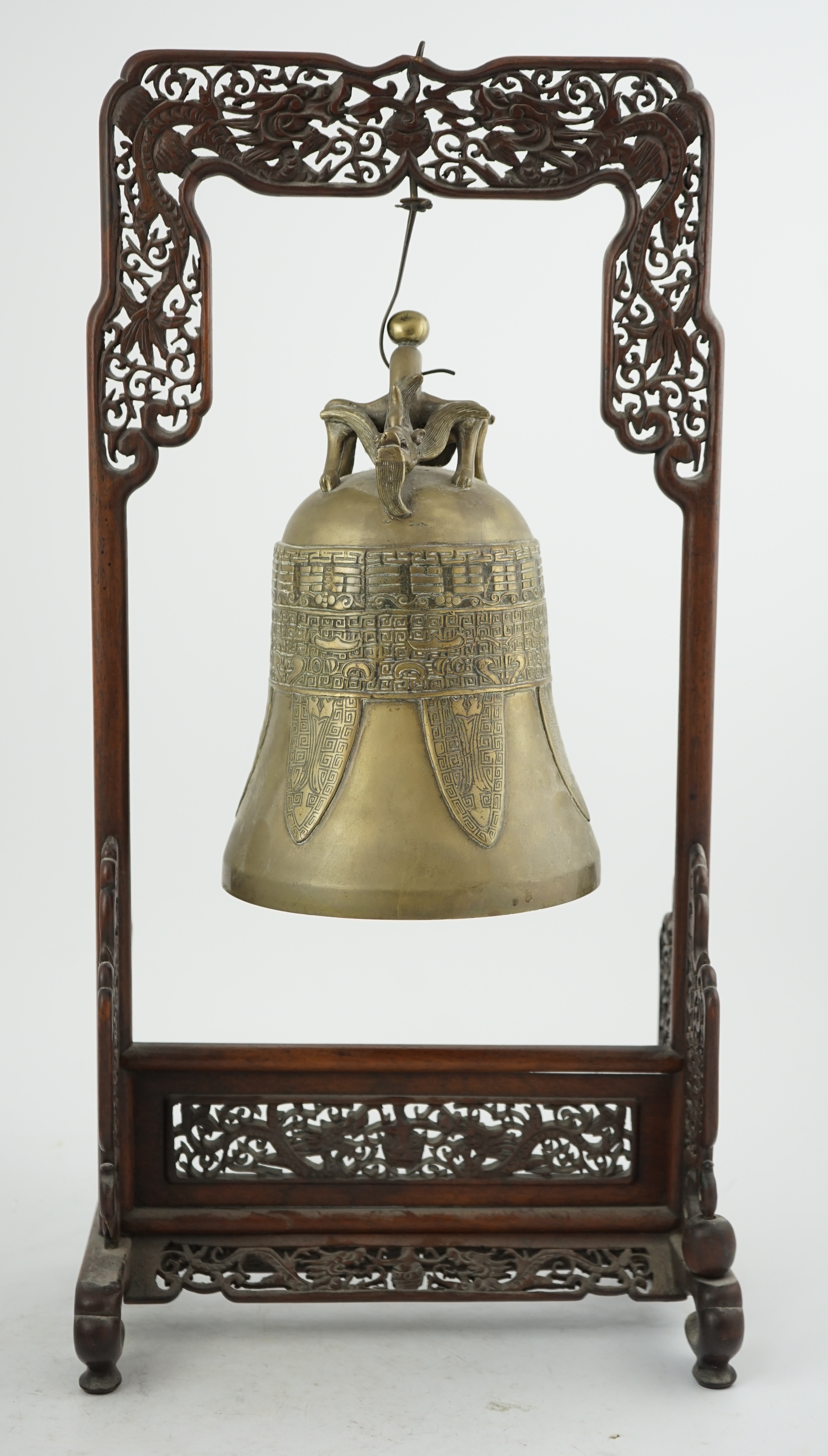 A Chinese archaistic bronze temple bell, and reticulated hardwood stand, Qing dynasty